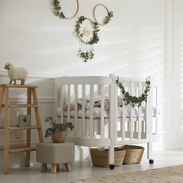 Stylish baby room decorated with eucalyptus branches